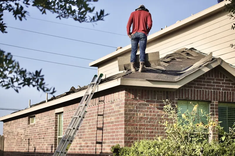 Professional roofer working on a residential roof in Waterford Place